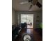 Living room featuring hardwood flooring, ceiling fan, and access to the screened in porch at 2717 Maitland Crossing Way # 4-103, Orlando, FL 32810