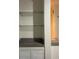 Built-in shelving unit featuring glass shelves and storage below, next to the sink and counter at 2717 Maitland Crossing Way # 4-103, Orlando, FL 32810
