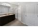 Bathroom with double vanity, granite countertops, tiled flooring, and a glass-enclosed shower at 3056 Sangria St, Kissimmee, FL 34744