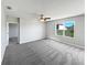 Large, light-filled bedroom features neutral walls, carpet, a ceiling fan, and ample natural light at 3056 Sangria St, Kissimmee, FL 34744