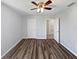 Bedroom with wood-look floors, ceiling fan, and white doors at 3056 Sangria St, Kissimmee, FL 34744