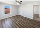 Bedroom with wood-look flooring, a window, and white door at 3056 Sangria St, Kissimmee, FL 34744