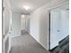 Bright hallway featuring neutral walls, carpet flooring, and white doors throughout at 3056 Sangria St, Kissimmee, FL 34744
