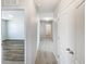 Hallway with neutral walls, carpet flooring, and white doors at 3056 Sangria St, Kissimmee, FL 34744