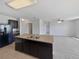 Kitchen island overlooks the living area and boasts a double sink and black cabinetry at 3056 Sangria St, Kissimmee, FL 34744