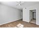 Bedroom with wood floors and a closet with access to a hallway and closet at 3398 Greenwich Village Blvd # 104, Orlando, FL 32835