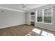 Bright, airy bedroom with hardwood floors, built-in desk, a ceiling fan, and a large window at 3398 Greenwich Village Blvd # 104, Orlando, FL 32835