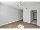 Bedroom with hardwood floors, ceiling fan, closet and two doors at 3398 Greenwich Village Blvd # 104, Orlando, FL 32835