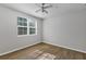 Bedroom featuring hardwood floors, a ceiling fan, and a bright window at 3398 Greenwich Village Blvd # 104, Orlando, FL 32835