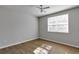 Bedroom featuring hardwood floors, a ceiling fan, and a bright window at 3398 Greenwich Village Blvd # 104, Orlando, FL 32835
