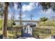 View of a wooden dock over the water with trees and a gazebo at 3398 Greenwich Village Blvd # 104, Orlando, FL 32835