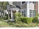View of the home's attractive exterior with lush landscaping and a welcoming covered porch at 3398 Greenwich Village Blvd # 104, Orlando, FL 32835