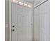 Bright white front door with transom window and sidelight, offering a welcoming entrance at 3398 Greenwich Village Blvd # 104, Orlando, FL 32835