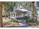 Exterior of the white gazebo, with brick pathway and view of the lake at 3398 Greenwich Village Blvd # 104, Orlando, FL 32835