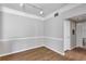 Spacious living room area with wood floors, white trim, and neutral paint with access to hallways and rooms at 3398 Greenwich Village Blvd # 104, Orlando, FL 32835