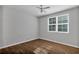 Bedroom featuring wood floors, a ceiling fan, and a large window with plenty of natural light at 3398 Greenwich Village Blvd # 104, Orlando, FL 32835