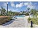 Community pool and pool deck offer lounge chairs, beautiful landscaping, and great sun exposure at 3398 Greenwich Village Blvd # 104, Orlando, FL 32835