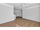 Open concept living room featuring wood floors, white trim, and a view of the adjacent rooms at 3398 Greenwich Village Blvd # 104, Orlando, FL 32835
