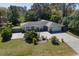 View of a single-story home with brick accents, lush landscaping, and an expansive driveway at 352 Ridgewood St, Altamonte Springs, FL 32701