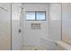 Bathroom with a windowed shower, built-in mosaic shelf, seat and honeycomb tile flooring at 3605 S Saint Lucie Dr, Casselberry, FL 32707
