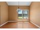 Dining area with wood flooring, a hanging light fixture, and a large window showcasing the backyard at 3605 S Saint Lucie Dr, Casselberry, FL 32707