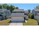 Two-story home featuring a two-car garage and mature landscaping at 3605 S Saint Lucie Dr, Casselberry, FL 32707