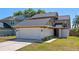 Inviting two-story home with a well-maintained lawn and a two-car garage at 3605 S Saint Lucie Dr, Casselberry, FL 32707