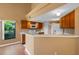 Open kitchen with wood cabinets, a microwave, and a breakfast bar that connects to the dining area at 3605 S Saint Lucie Dr, Casselberry, FL 32707