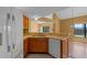 Kitchen area with double sink, white appliances, and an adjoining dining area and backyard view at 3605 S Saint Lucie Dr, Casselberry, FL 32707