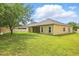 Spacious backyard featuring lush lawn and covered patio area at 3747 Moon Dancer Pl, St Cloud, FL 34772