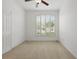 Bedroom with neutral carpet, ceiling fan, and a shuttered window overlooking the front yard at 3747 Moon Dancer Pl, St Cloud, FL 34772