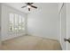 Bedroom with neutral carpet, ceiling fan, shuttered window and closet at 3747 Moon Dancer Pl, St Cloud, FL 34772