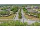 Aerial view of a neighborhood entrance featuring landscaped medians and decorative pergolas at 3747 Moon Dancer Pl, St Cloud, FL 34772