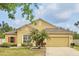 Charming single-Gathering home with well-manicured lawn and tropical landscaping, featuring a two-car garage at 3747 Moon Dancer Pl, St Cloud, FL 34772