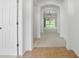 Bright hallway with neutral tones, archways, ceramic tile at the door, and view to backyard at 3747 Moon Dancer Pl, St Cloud, FL 34772