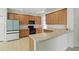 Spacious kitchen featuring modern appliances, light wood cabinetry, and laminate countertops at 3747 Moon Dancer Pl, St Cloud, FL 34772
