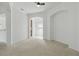 Living room with neutral carpet and paint featuring archways looking to the kitchen and dining room at 3747 Moon Dancer Pl, St Cloud, FL 34772