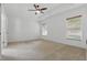 Spacious main bedroom featuring a tray ceiling, ceiling fan, and neutral carpet at 3747 Moon Dancer Pl, St Cloud, FL 34772
