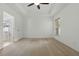 Bright main bedroom with carpet, ceiling fan, and an ensuite bathroom at 3747 Moon Dancer Pl, St Cloud, FL 34772