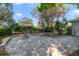 Backyard patio has paved flooring, a built in fire pit, and a view of the landscaped lawn at 400 W 2Nd Ave, Windermere, FL 34786