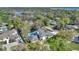 Aerial shot showcasing home and pool surrounded by lush, mature trees at 409 W 2Nd Ave, Windermere, FL 34786