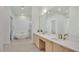 Bright bathroom featuring a soaking tub, double vanity with gold fixtures, and a large mirror at 409 W 2Nd Ave, Windermere, FL 34786