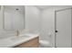 Bright bathroom featuring a modern vanity, toilet, mirror, and gold hardware at 409 W 2Nd Ave, Windermere, FL 34786