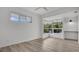 Bright bedroom featuring hardwood floors, a ceiling fan, and large windows for ample natural light at 409 W 2Nd Ave, Windermere, FL 34786