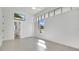 Sun-filled bedroom with tile floors, large windows, and an ensuite bathroom at 409 W 2Nd Ave, Windermere, FL 34786