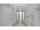 Spacious closet with custom shelving units and mirrored doors that lead to the bathroom at 409 W 2Nd Ave, Windermere, FL 34786