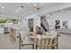 Open-concept kitchen and dining area featuring an island, modern lighting, and stainless steel appliances at 409 W 2Nd Ave, Windermere, FL 34786