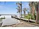 Picturesque dock extending into calm waters, framed by trees draped with Spanish moss, creating a serene retreat at 409 W 2Nd Ave, Windermere, FL 34786