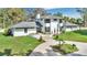Stunning curb appeal of this modern two-story home with gray roof and manicured lawn and circular driveway at 409 W 2Nd Ave, Windermere, FL 34786