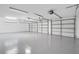 Spacious three-car garage with epoxy flooring, providing ample storage and parking at 409 W 2Nd Ave, Windermere, FL 34786